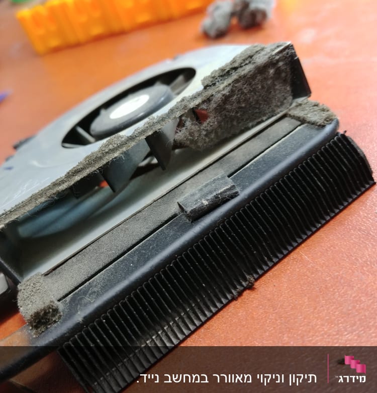 מאוורר מחשב מלוכלך באבק על שולחן עבודה